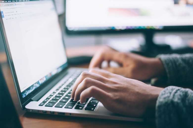 Man typing on the Macbook